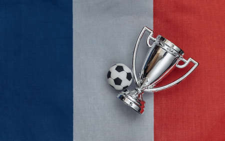 Champion cup with soccer ball on French flag. Sport competitionsの写真素材