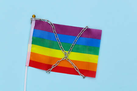 LGBT rainbow flag wrapped in steel chain. Intoleranceの写真素材
