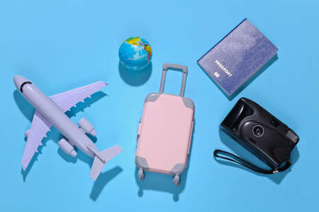 Travel flat lay. Travel accessories on blue background with deep shadow. minimal style. top viewの写真素材