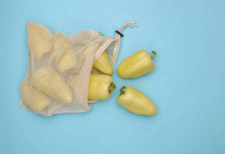 Bell peppers in eco bag on blue background. top viewの写真素材