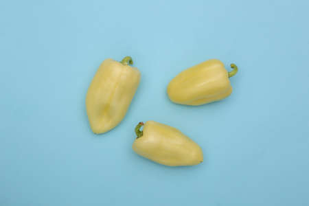 Bell peppers on blue background. top view