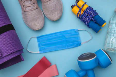 Fitness training during the covid-19 period. Flat lay composition of fitness outfit, accessories,...