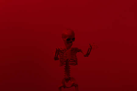 Scary skeleton in red dark lightの写真素材