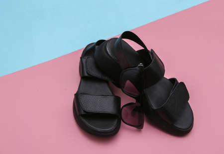 Leather sandals on a blue pink background.