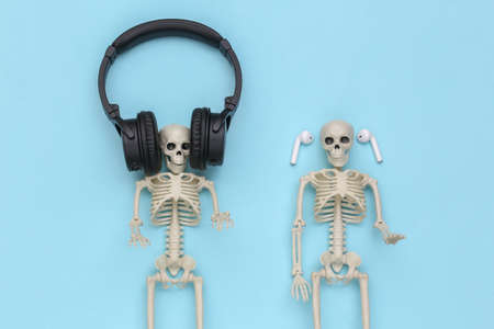 Skeletons in headphones on a blue background. top viewの写真素材