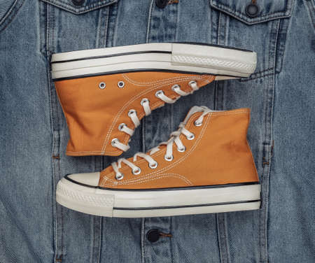 Youth retro high-top sneakers on a denim background.の写真素材