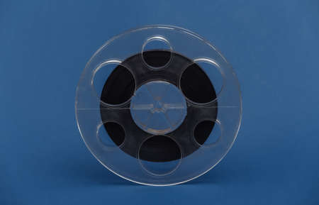 Reel of magnetic audio tape on classic blue backgroundの写真素材