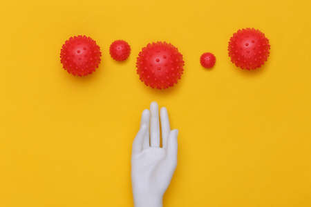 Mannequin hand and virus strain on yellow background. Covid-19. top viewの写真素材