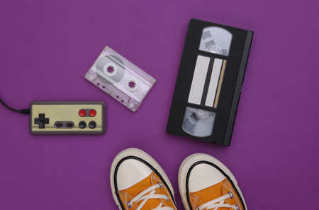 Gumshoes and retro entertainment attributes on a purple background. top viewの写真素材