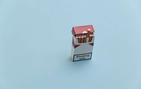 Ppack of cigarettes on blue background. smoking kills.