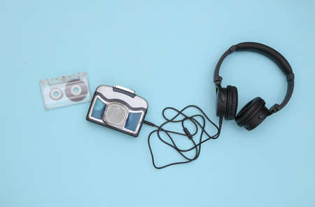 Mini audio player with stereo headphones on a blue background. top viewの写真素材