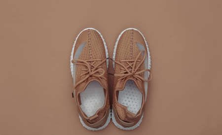 Textile sports shoes on brown background. top viewの写真素材