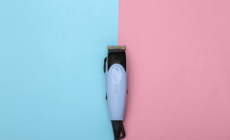 Hair clipper on a pink blue pastel background. top viewの写真素材