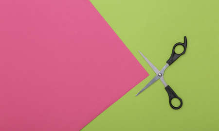 Scissors on pink green background. top view. copy spaceの写真素材