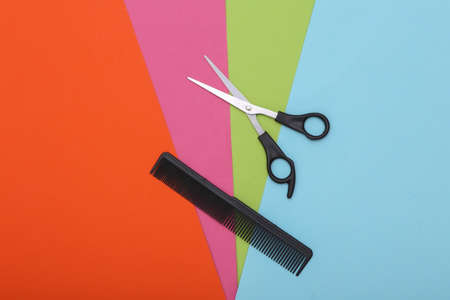 Comb and scissors on colorful background. barber tool. top viewの写真素材