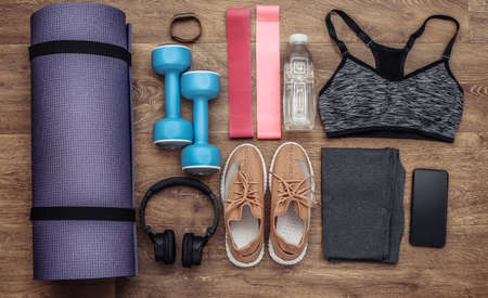 Flat lay composition of Sports equipment, clothes on a wooden floor. Fitness, sport and healthy lifestyle concept. top viewの写真素材