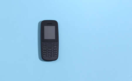 Push button telephone on blue background. top viewの写真素材