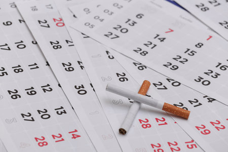 Quit smoking concept. Monthly calendar and cigarettesの写真素材