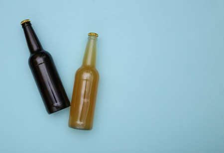 Bottle of light and dark beer on a blue background. copy spaceの写真素材