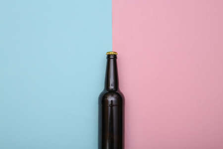 Bottle of dark beer on pink blue background. top viewの写真素材
