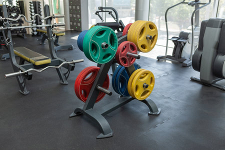 Rack with discs from a bar in a modern gym