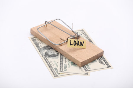 Mousetrap with loan bait and dollar bills on white background. Traps, risks or deception conceptの写真素材
