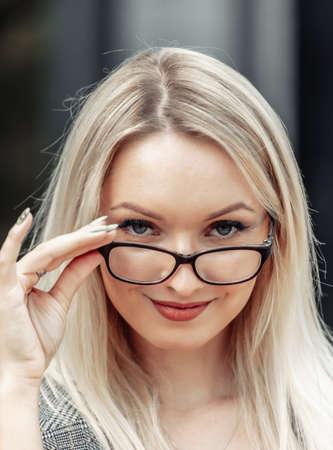 Facial portrait of blonde business woman wearing glasses close upの写真素材