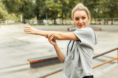 Young fit blonde woman warm up before training outdoors. Aerobicsの写真素材