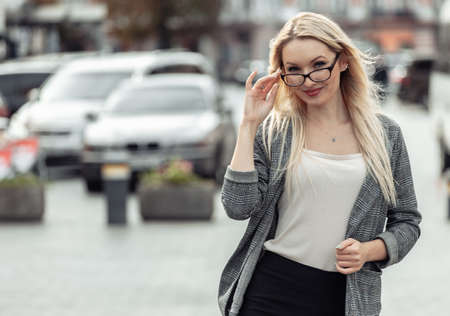 Portrait of a business woman in the city. Young blonde girl in business clothesの写真素材