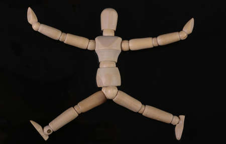 Wooden puppet mannequin isolated on black backgroundの写真素材