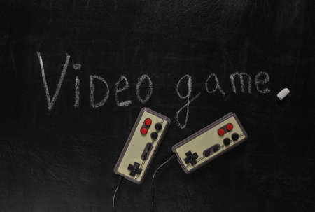 Retro joysticks and Word video game chalk hand drawn on blackboard