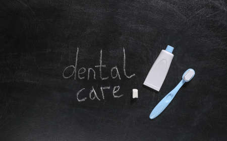 Dental care supplies and Words dental care chalk hand drawn on blackboard