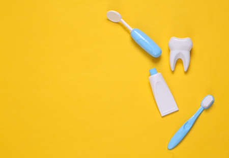 Toy dentist equipment on yellow background. copyspace. top view. flat layの写真素材