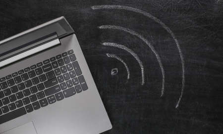Laptop and wifi symbol chalk hand drawn on blackboard