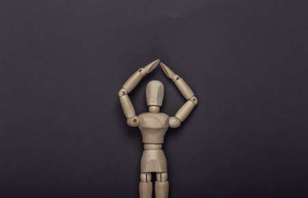 Protected wooden mannequin on gray backgroundの写真素材