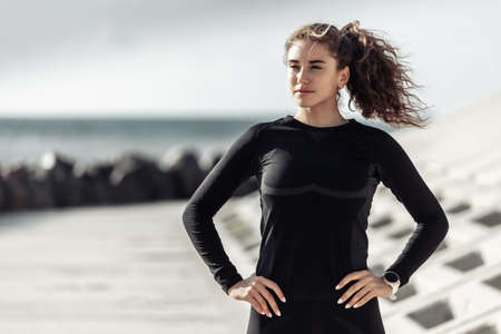 Curly sport woman in sportswear on urban beach. healthy lifestyleの写真素材