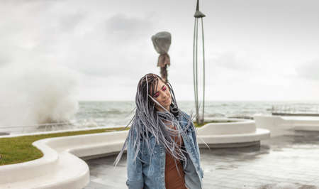 Portrait of informal woman with afro braids and bright makeupの写真素材