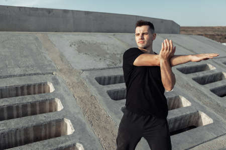 Active muscular man exercising outdoors on concrete slabs. healthy lifestyle conceptの写真素材