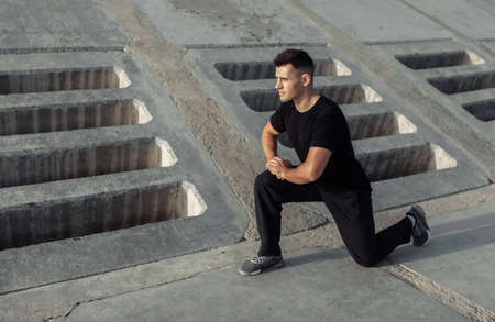 Active muscular man exercising outdoors on concrete slabs. healthy lifestyle conceptの写真素材