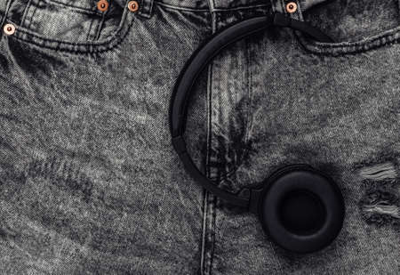 Stereo headphones in the pocket of gray jeanの写真素材