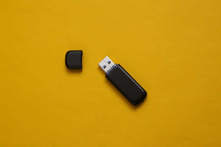 USB flash drive stick on yellow backgroundの写真素材