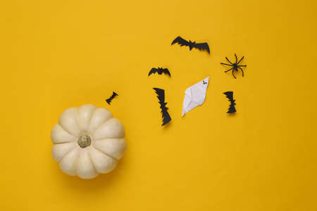 Halloween handmade decor and pumpkin on yellow background. flat lay. top viewの写真素材