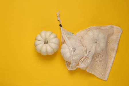 Eco bag with mini pumpkins on yellow backgroundの写真素材