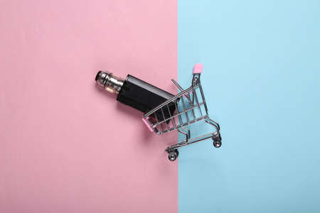 Shopping trolley with vaping device (electronic hookah or cigarette) on pink blue background. top...