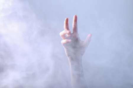 Hand in dense smoke. Mystical Halloween themeの写真素材