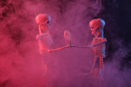 Skeletons in dense smoke with red purple neon light. Scary Halloween themeの写真素材