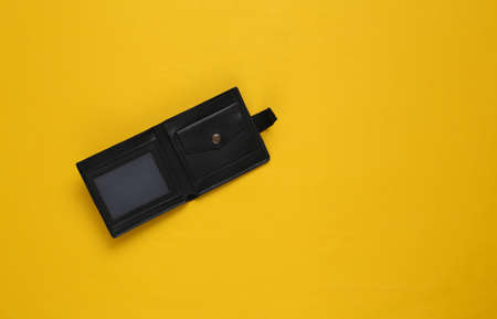 Empty leather open wallet on yellow backgroundの写真素材