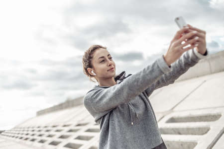 Sport And Attractive Woman Taking Selfie On Smartphone Outdoorsの写真素材