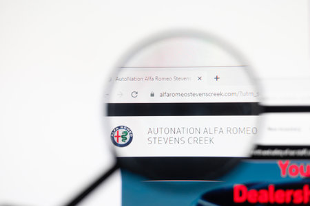 Odessa, Ukraine - December 17, 2020: Alfa romeo website on monitor screen under magnifying glass.
