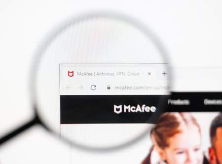 Odessa, Ukraine - December 17, 2020: Mcafee antivirus website on monitor screen under magnifying glass.のeditorial素材